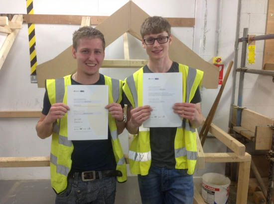 Apprentices displaying their certificates