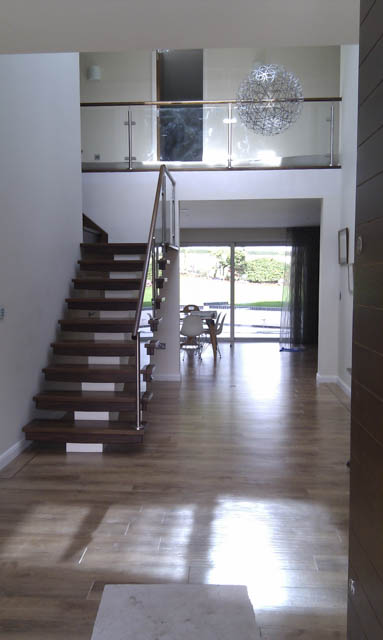 A photograph of an Applewood Joinery Ltd open riser staircase.